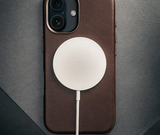 MagSafe charger attached to the Dark Brown Leather Slimline Bumper Case for iPhone 16