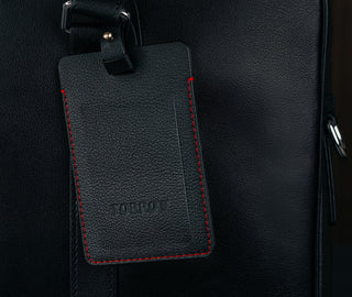Black with Red Stitching Leather Luggage Tag attached to luggage