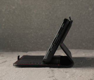 Demonstrating the integrated stand function of the Black Leather (with Red Stitching) Stand Case for Galaxy S20 FE 5G