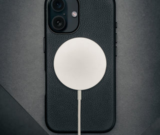MagSafe charger connected to the Black Leather Slimline Bumper Case for iPhone 16
