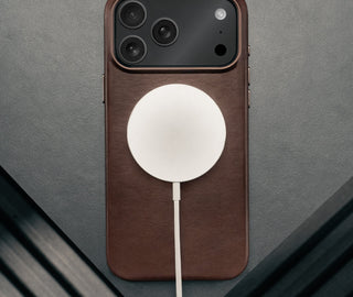 MagSafe charger attached to the Slimline Dark Brown Leather Bumper Case for iPhone 17 Pro Max