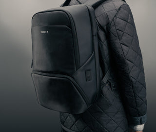 Man carrying the Black Commuter Backpack