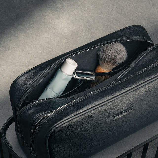 Toiletry items inside the Black Leather Wash Bag